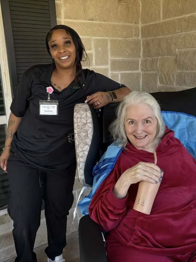 A caregiver with a smiling resident at The Sage Oak of Colleyville