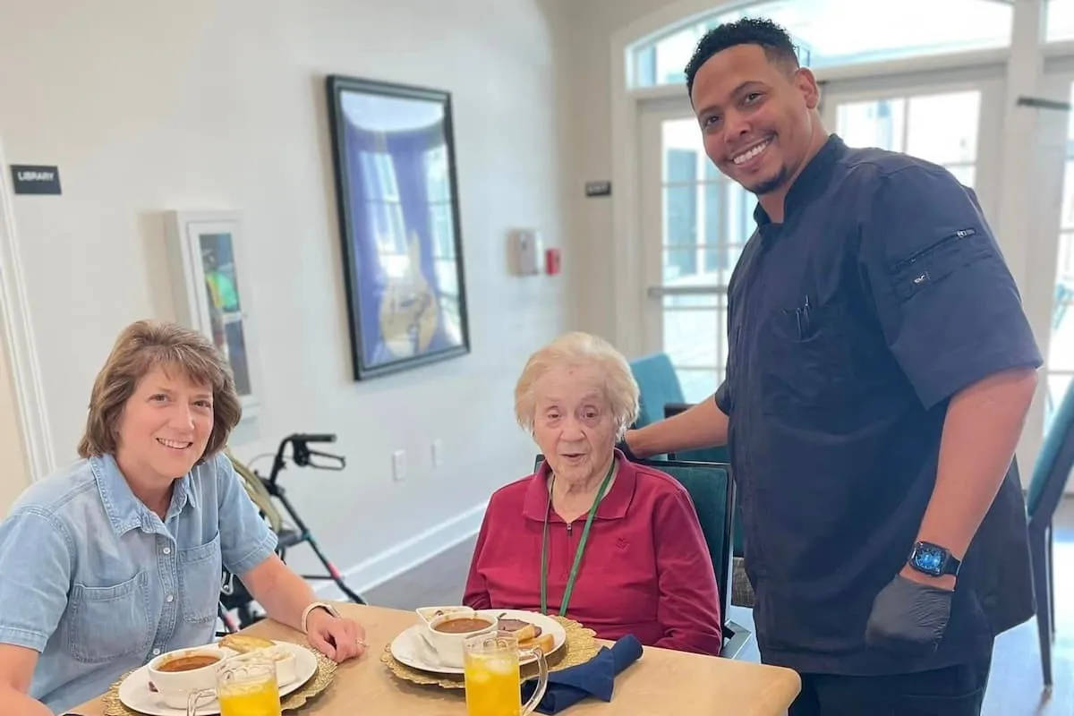A team member, a resident and the chef together at The Sage Oak of Lake Charles