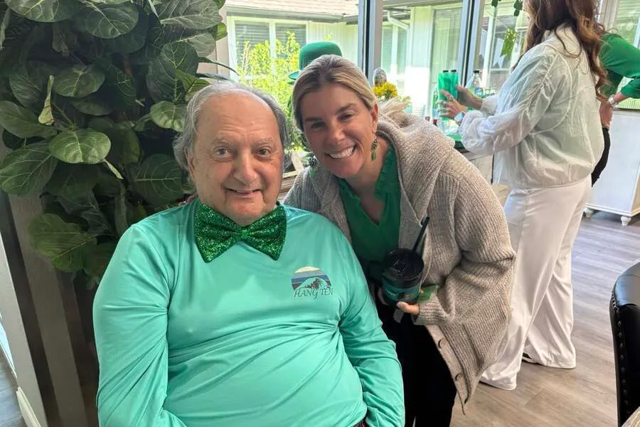 A resident and a family member smiling together