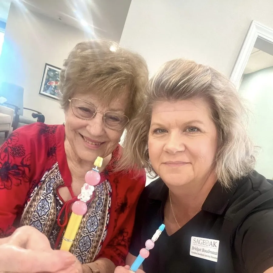 A team member and a resident smiling together in Lake Charles